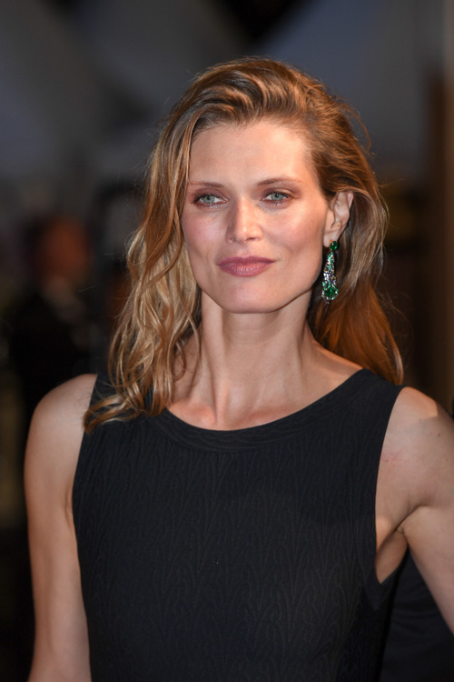 Malgosia Bela wore earrings from Chaumet est une fête collection to accompany her Film Director husband at the Premiere of his film at the Cannes Film Festival.  Earrings in white gold, yellow gold and lacquer, set with two cushion-cut emeralds  from Colombia Muzo, two cabochon-cut emeralds from Zambia, round rubies and emeralds, baguette-cut sapphires and yellow sapphires, and brilliant-cut diamonds
