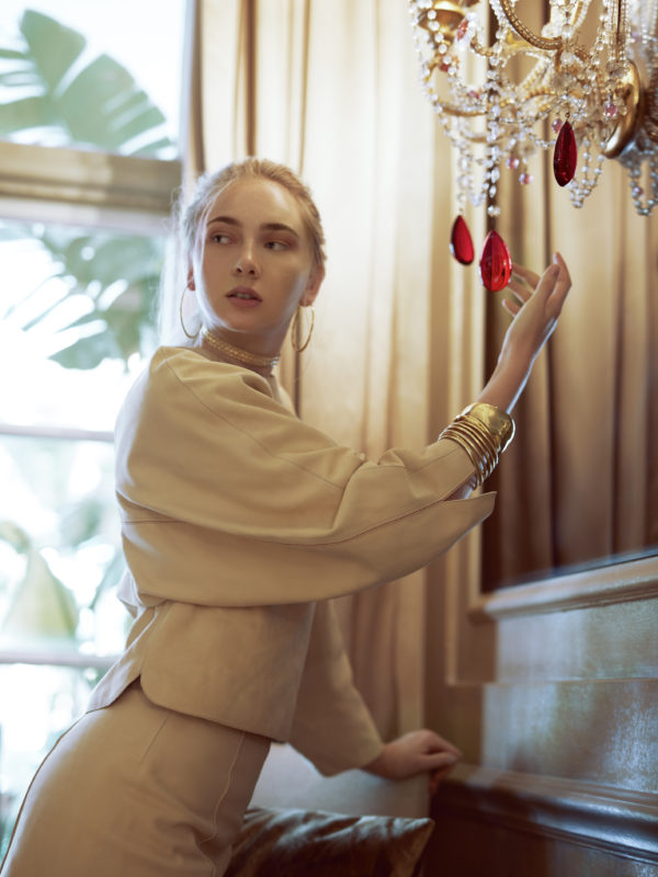 Suede top and shorts by Hermés; gold choker by Noor Fares; gold earrings by Dinny Hall. 
Bracelets (left to right): Gold multi-hoop bracelet by Dinny Hall; gold bracelet and gold cuff by Pippa Small.